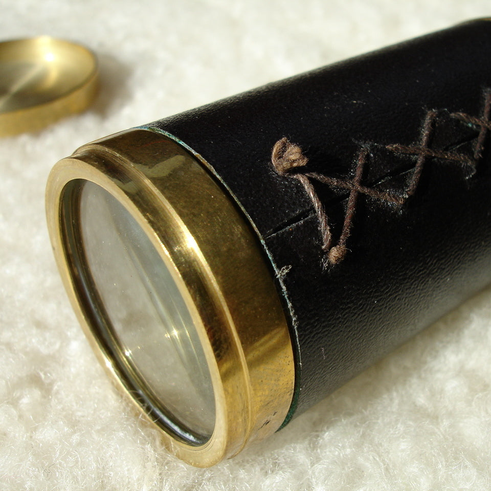 Magis Art Shop vintage style brass monocular telescope with black leather casing and decorative cross-stitch detail