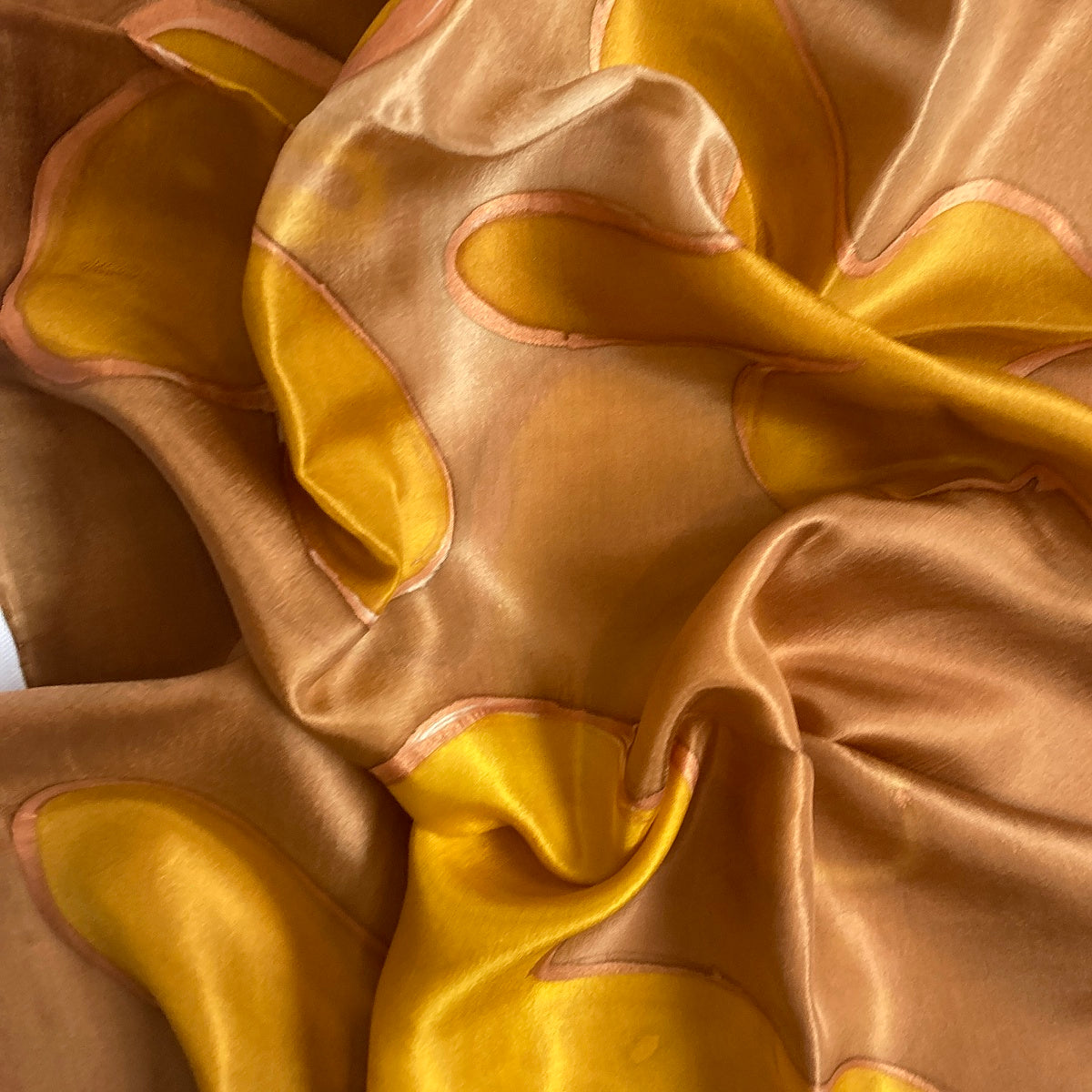 Magis Art Shop hand-painted brown and honey yellow 100% silk scarf with abstract flowing patterns and glossy texture.