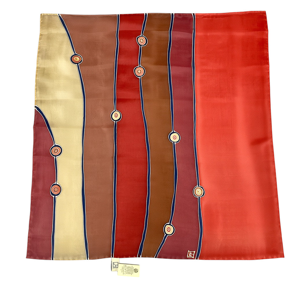Magis Art Shop hand-painted natural silk scarf in burgundy, brown, and cream with abstract circular line patterns.