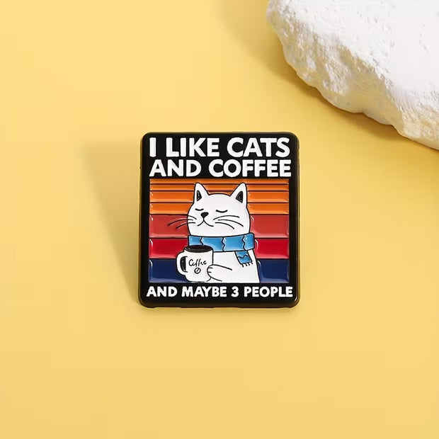 Magis Art Shop rectangular enamel pin featuring a cat holding a coffee mug with a retro sunset background