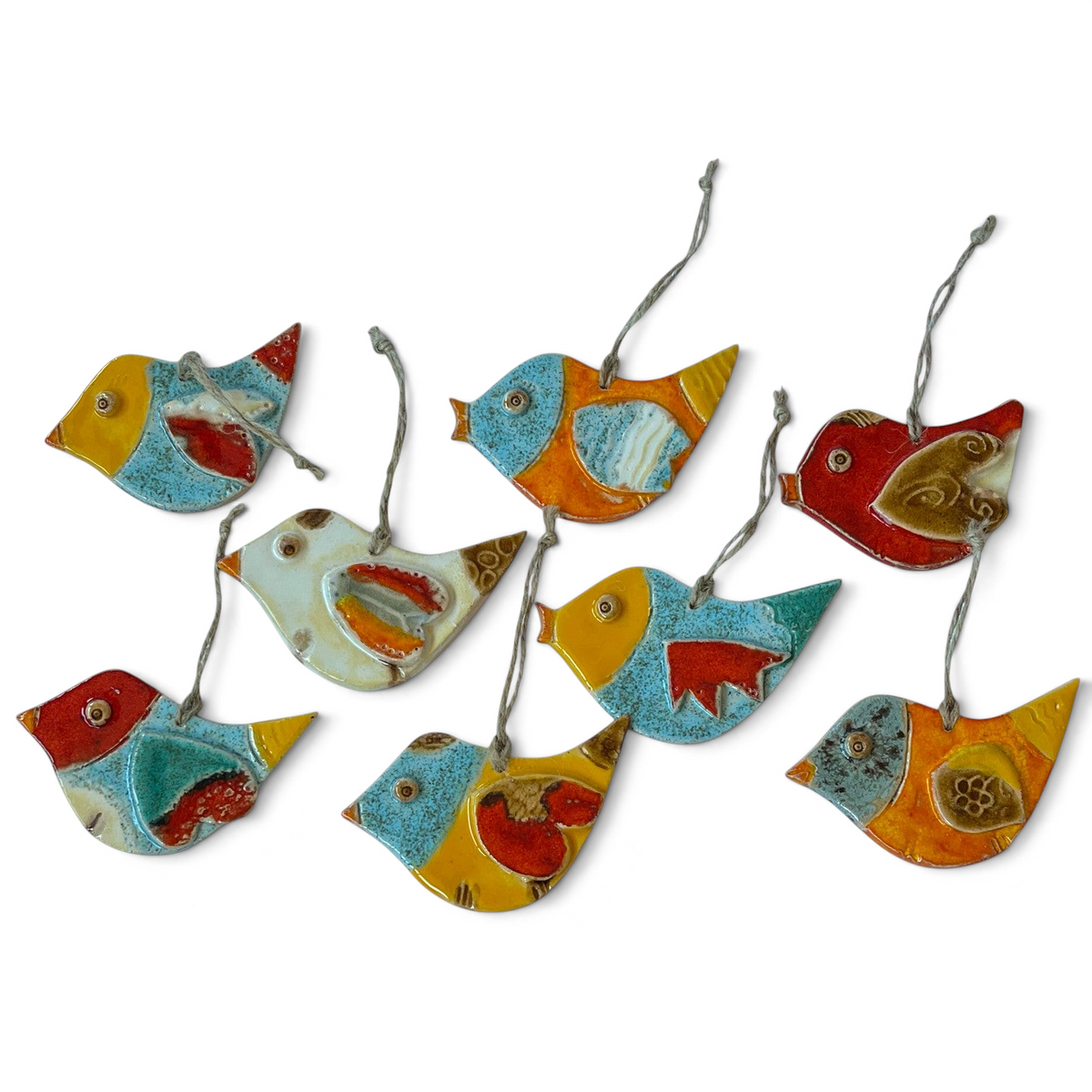 Magis Art Shop ceramic bird ornaments in various vibrant colors with hanging strings, handmade by Janka Blašková.