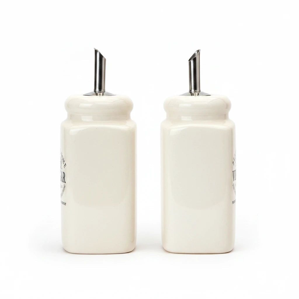 Magis Art Shop set of two cream ceramic oil and vinegar cruets with stainless steel pourers, 13 cm tall