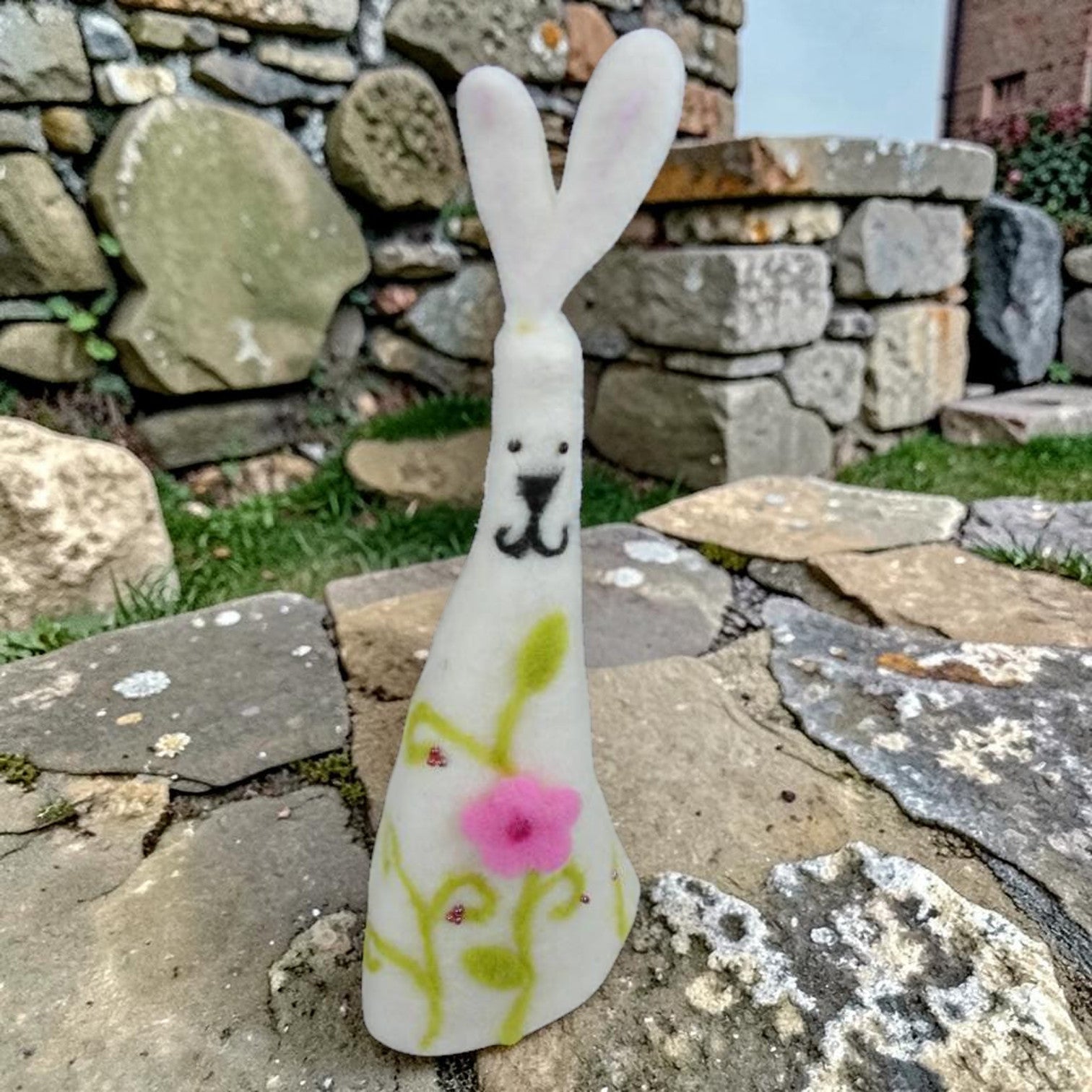 Magis Art Shop white felt Easter bunny decoration with hand-painted pink flower and green vine design