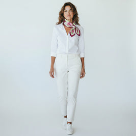 Magis Art Shop silk scarf with floral pattern worn by a woman in a white shirt and trousers against a plain background