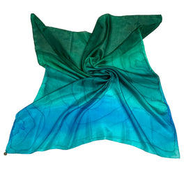Magis Art Shop Elena Ruta Marchallé square silk scarf in a green and blue gradient with abstract line patterns.
