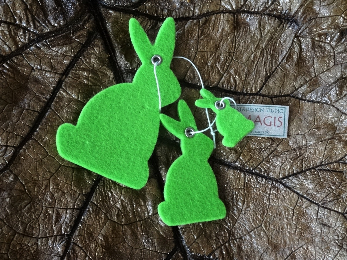 Magis Art Shop green felt bunny hanging decorations in three different sizes on a dark leaf background