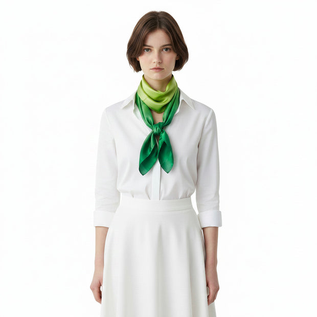 Magis Art Shop hand-painted green silk scarf worn by a woman in a white shirt
