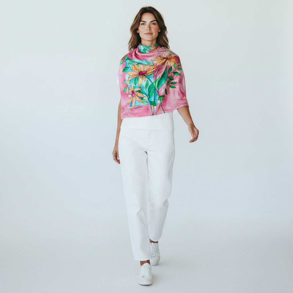 Magis Art Shop hand-painted pink silk scarf with floral pattern worn by a woman in white casual clothing