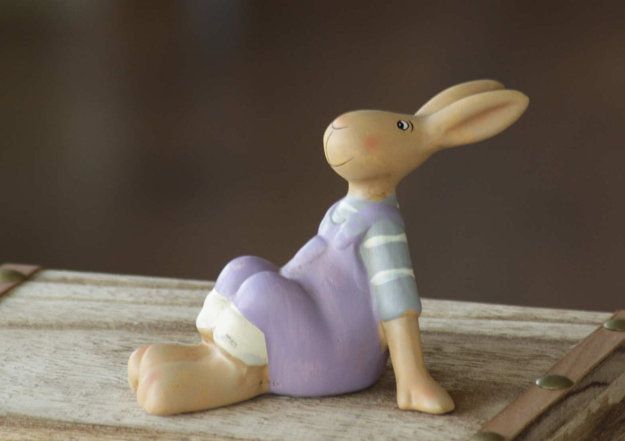 Magis Art Shop ceramic Easter bunny figurine in purple overalls sitting on a wooden surface