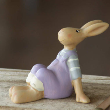 Magis Art Shop ceramic Easter bunny figurine in purple overalls sitting on a wooden surface