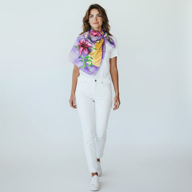 Magis Art Shop purple silk scarf with floral pattern worn by a woman in a white t-shirt and white jeans