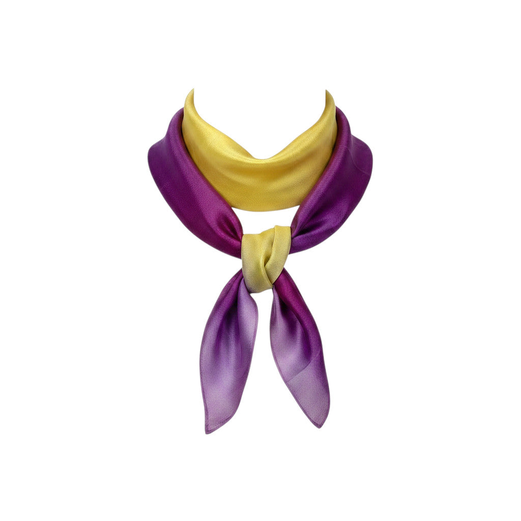 Magis Art Shop hand-painted purple and yellow silk scarf with a soft sheen, tied in a classic knot style.