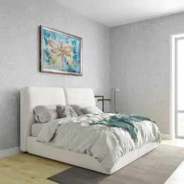 Magis Art Shop silk painting of a dragonfly with gold details and floral wreath hanging above a modern white bed