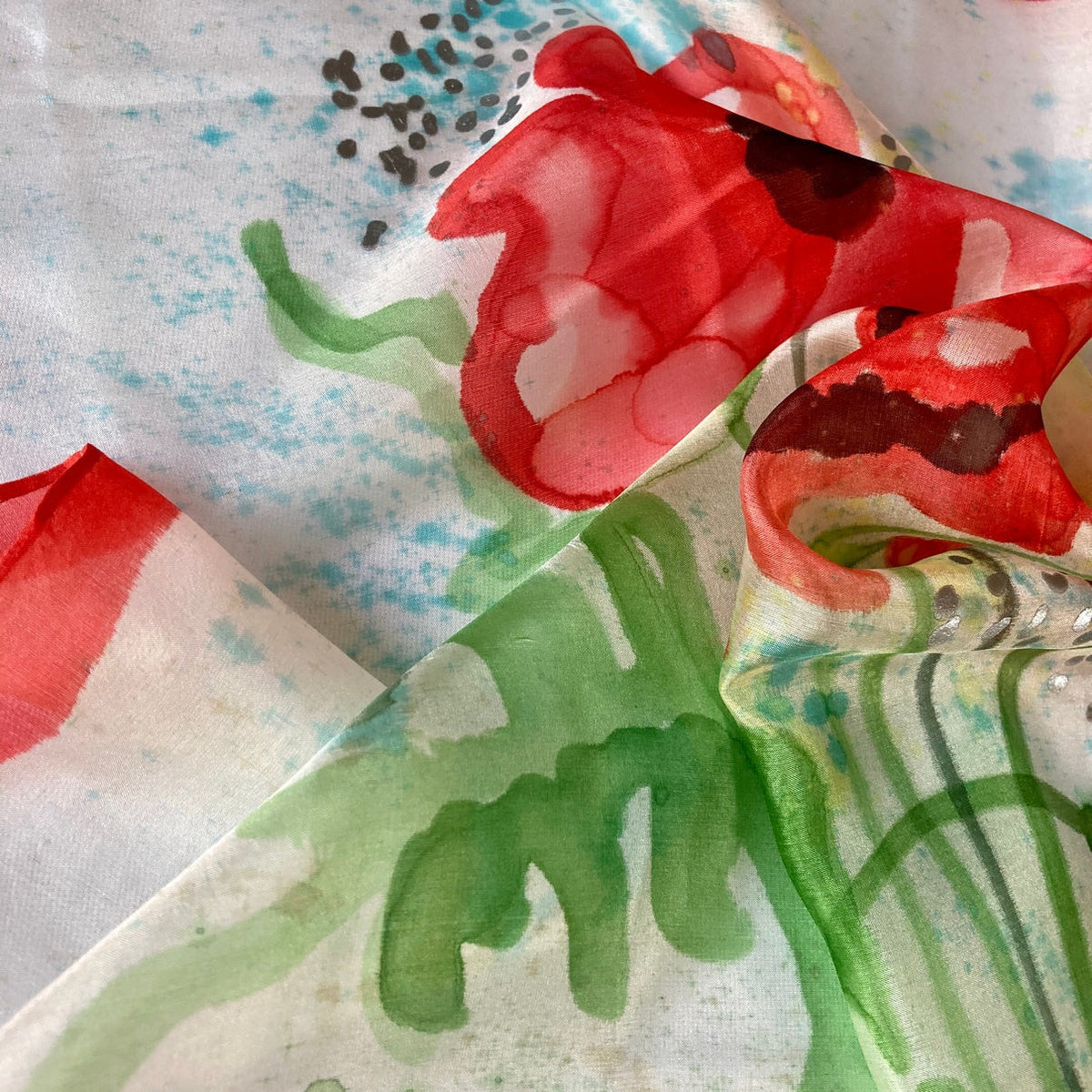 Magis Art Shop silk scarf featuring a hand-painted red poppy floral pattern on a white background
