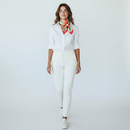 Magis Art Shop silk scarf with rose pattern worn by a woman in a white shirt and trousers