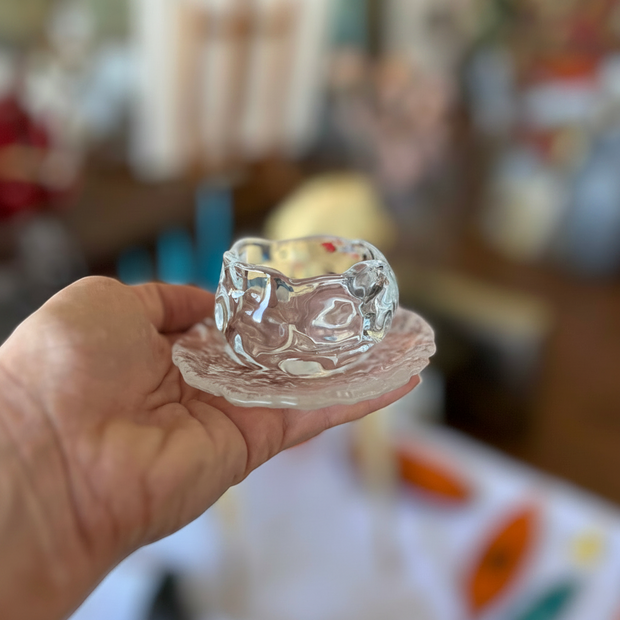 Magis Art Shop small clear glass cup with matching textured saucer held in a hand
