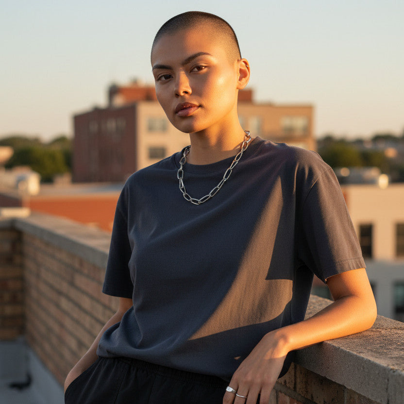 Magis Art Shop stainless steel chain necklace with large links worn by a model on a rooftop at sunset