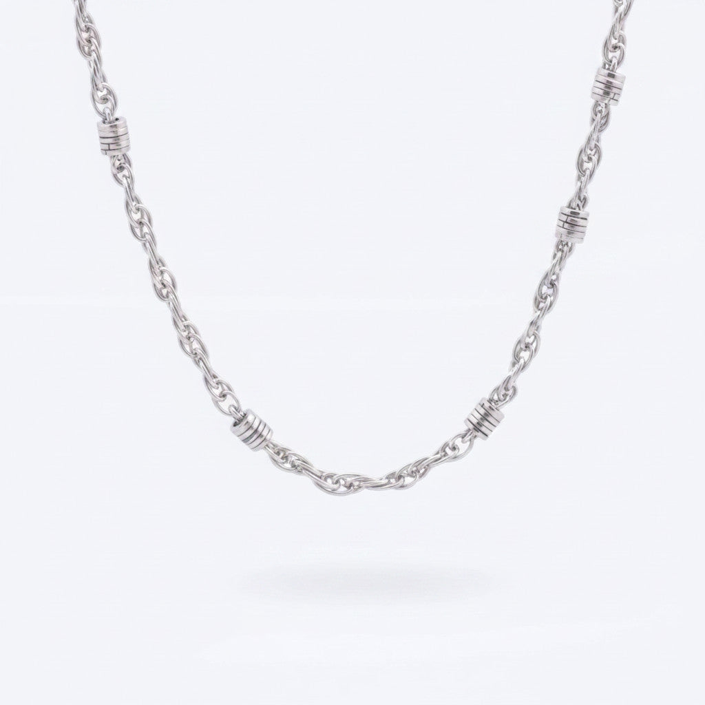 Magis Art Shop stainless steel chain necklace featuring decorative silver-toned rings along a 50 cm twisted link chain