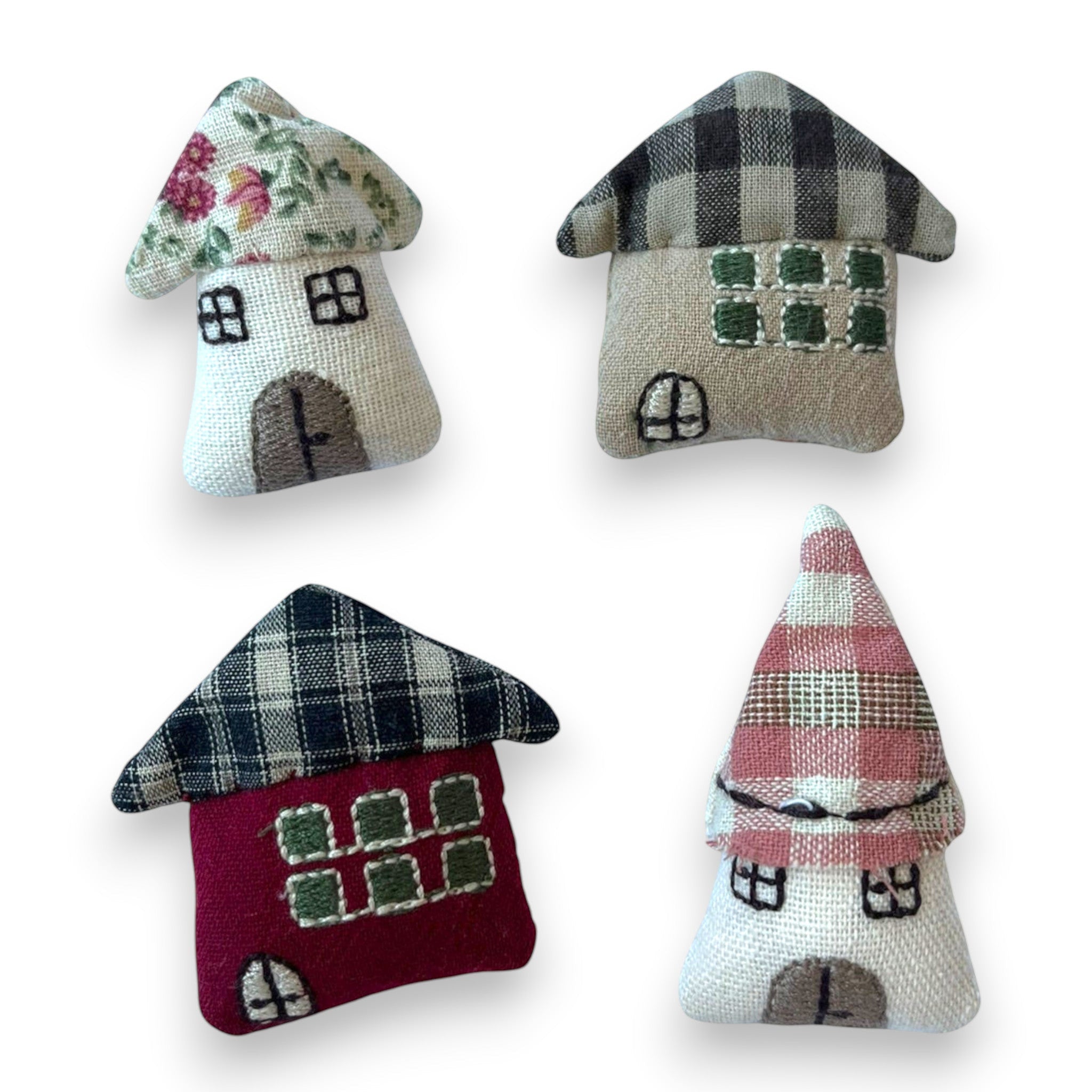 Magis Art Shop set of four small handmade textile house brooches with floral, plaid, and solid fabric patterns.