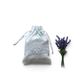 Magis Art Shop white cotton drawstring pouch with delicate lace embroidery, perfect for herbs or small gifts.