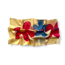 Magis Art Shop yellow silk scarf by Ria Berec featuring hand-painted vibrant red and blue floral patterns.